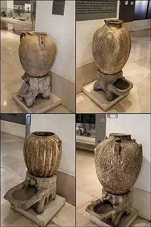 Marble jars and stands with engraved ornamentation