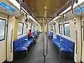 Interior of second generation trains. With 3 rows of handrails and hanging strap. Along with dynamic route map.