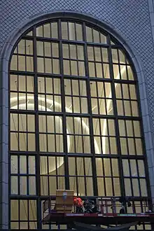 The main entrance arch as seen in 2021, during the building's renovation. There is a construction worker at the bottom of the arch.