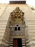 Pyramidal muqarnas canopy, along with ablaq, marble mosaic, and carved stone decoration, in the portal of the Madrasa of Umm al-Sultan Shaban (1368)