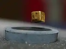 A magnet is suspended over a liquid nitrogen cooled high-temperature superconductor (−200 °C)