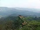 Pratapgad fort walls snaking along the edge of the hill