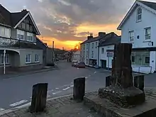 Centre of the village of Maiden Newton with the village cross in foreground