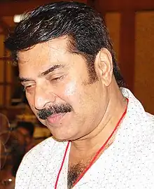 Close-up shot of Mammootty, who is looking downwards