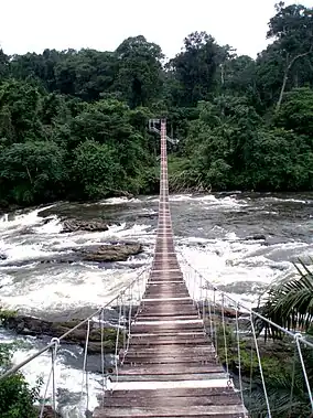 Wooden suspension bridge over a river.