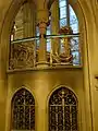 Gothic style ironwork, on the lower flight of the Main Staircase, Manchester Town Hall, with typical Waterhouse glass in the background