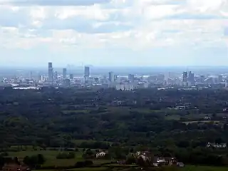 View of Manchester from Hartshead Pike, 8 miles (13 km) away with Fiddlers Ferry Power Station beyond,  27 miles (43 km) away.