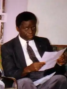 Lihau seated with papers in his hands