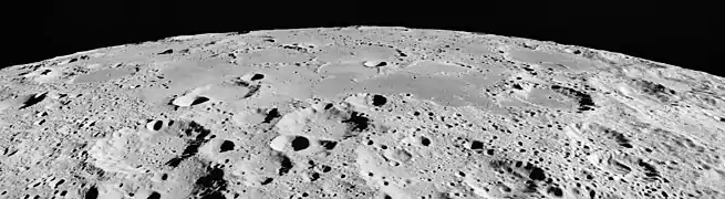 Oblique view of Mare Australe on the moon, facing south, from Apollo 15.  The crater Abel is at right, Gernsback is at left, with Donner in the left foreground.  The craters Lamb, Jenner, and Gum are visible on the horizon (from left to right).