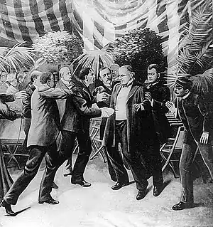 Illustration of Leon Czolgosz shooting William McKinley, with a gun concealed beneath a handkerchief