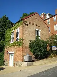 Photograph of McSherry Hall partially covered in ivy