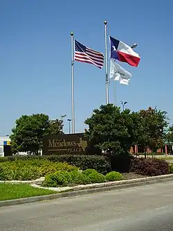 A sign indicating Meadows Place