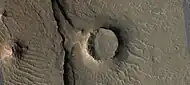 Eroded craters, as seen by HiRISE.  One crater is half eroded away.  Another crater has eroded to form a tall, thin rim, and its ejecta has been eroded away.  This image is part of an image that was named HiRISE picture of the day.