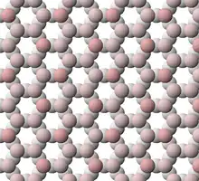 View of tetrahedral sheet structure of mica. The apical oxygen ions are tinted pink.