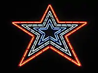 The Star with red, white, and blue neon lights illuminated.