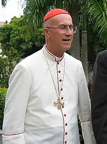 Catholic Cardinal Tarcisio Bertone wearing a tropical white cassock trimmed in cardinalatial scarlet in Santo Domingo, Dominican Republic (2006).