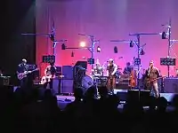 Shows members of Modest Mouse performing in concert