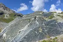 Glacial striations on an eroded rock alongside the Moiry Glacier, Switzerland, visible in the lower right quarter of the image