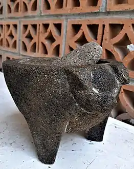 Tripod molcajete with a pig's head decoration, originating from San Salvador el Seco, Puebla, México; a very popular model in the taquerías (taco shops) of México City