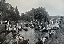 A postcard photograph of people boating on the River Thames near Molesey Lock c1897