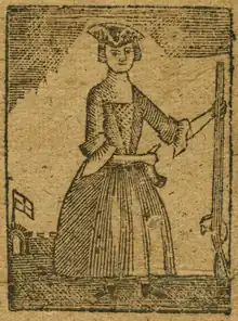 A woodcut of a woman. The color is mostly brown with black lines. The woman stands center, wearing a tricorn hat and a dress with sleeves to her elbows and a skirt to her shoes. She faces the viewer. In her left hand she holds the end of a rifle, its buttstock resting on the ground. Her right arm crosses her waist with her hand clasping something at her left hip that is curved; possibly a horn? Or a waterskin? In the background in the lower left, a flat waves off in the distance.