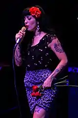 A color photograph of Mon Laferte performing.