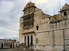 Monsoon palace entrance against backdrop of cloudy skies