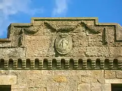 The Montgomerie family crest on the castle ruins. The Motto reads as 'Garde Bien' translating as 'Hazard Yet Forward' or 'Guard Well'.