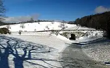 The MST crossing under a snowy Blue Ridge Parkway in Moses H. Cone Memorial Park.