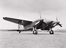 Twin-engined military monoplane parked on airfield