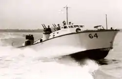 motor gun boat sailing at speed from left to right