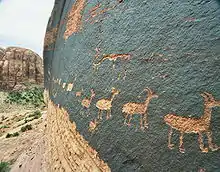 A petroglyph of a caravan of bighorn sheep near Moab, Utah, United States; a common theme in glyphs from the southwestern desert