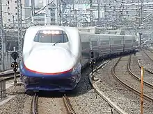 A JR East E2 series set N11 arriving at Tokyo Station on an Asama service in June 2002