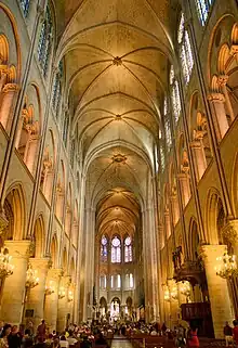 Interior of nave showing rib vaulting; in walls are clerestory windows (top), arches to triforium (middle), and arches to side aisles (bottom).