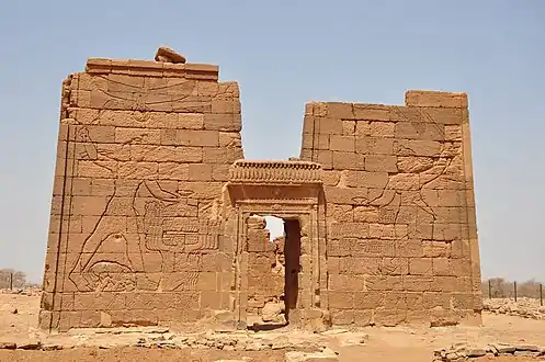 Temple of Apedemak in Naqa. Pylons depicting King Natakamani and Queen Amanitore smiting enemies. The queen holds a sword, the king an axe.