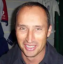 Headshot of Nasser Hussain, with white England kit in the background.