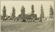 A tan and black blurry picture of two groups of men playing football with little protective equipment