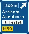 K2: Advance warning sign of a motorway showing the distance to the next exit and destinations after the exit (the top destination is the name of the exit), direction to aerodrome/airport and the road number (non-motorway)(old)