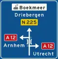 K5: Non-motorway advance information panel showing intermediary destinations, road numbers, a viaduct symbol and a sign for an industrial zone