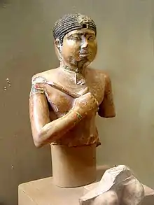 Bust of a pharaoh, holding a mace.