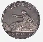 Helvetia seated, pointing left, holding Swiss shield. Legend above, denomination below.