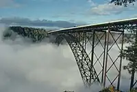 Bridge as seen from the National Park Service Visitors Center, with fog in the New River Gorge below