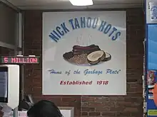 Sign: "Nick Tahou Hots," "Home of the Garbage Plate," "Established 1918."  Garbage Plate is illustrates with steaming hots, baked beans, bread and butter.