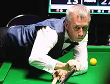 Nigel Bond playing a shot with the rest