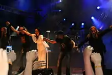 Five band members taking their bows at the end of a performance