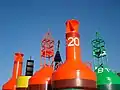 Several different buoys at a storage depot.