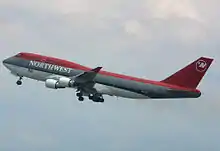 The 747-400 (N661US) with its landing gear down and flaps down.