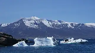 Qilertiinguit Kangilequtaa (2,070 m (6,791 ft)) seen from Uummannaq across the main arm of Uummannaq Fjord