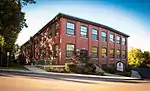 Red brick building overlooking street in late afternoon