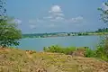 Bank of Oguta Lake showing farmland and vegetation.